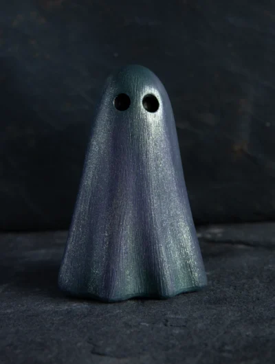 Ghost ornament is cloaked in deep purple, with hints of green and grey drifting through its folds. Finished with our signature Liquid Star, its surface catches the light with a quiet shimmer.